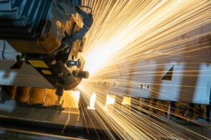 Sparks fly from a factory machine.