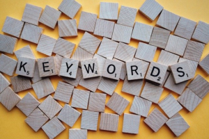 Scrabble tiles spelling out "keywords."