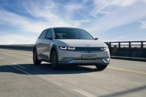 Hyundai Ioniq5 drives down a bridge.